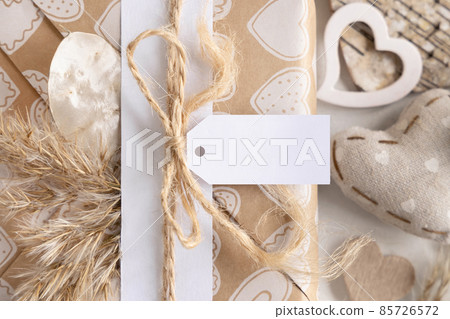 Valentines present with blank gift tag and heart close up, Rustic label Mockup 85726572