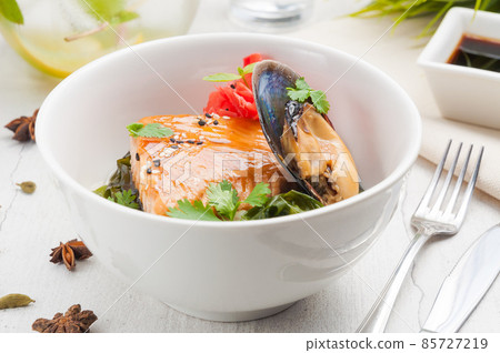 seafood salmon steak with mussels in a white bowl 85727219