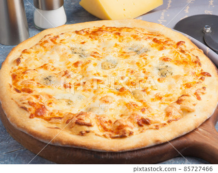 pizza four cheeses on a wooden Board pizza four cheeses on a wooden Board 85727466