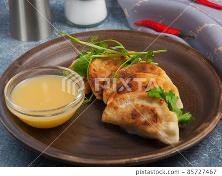 small meat pies posikunchiki with mustard sauce. Russian cuisine small meat pies posikunchiki with mustard sauce. Russian cuisine 85727467