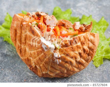 shaverma in pita or pita bread with chicken fillet and vegetables shaverma in pita or pita bread with chicken fillet and vegetables 85727604