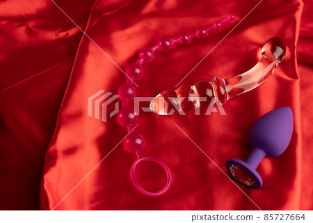 a collection of different types of sextoys on red satin a collection of different types of sextoys on red satin 85727664