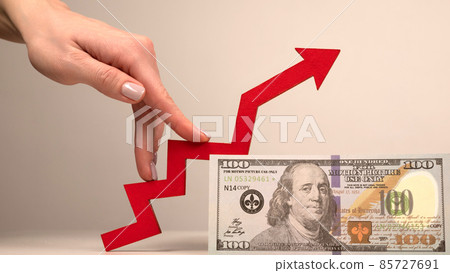 The fingers of a woman's hand step up the arrow  85727691