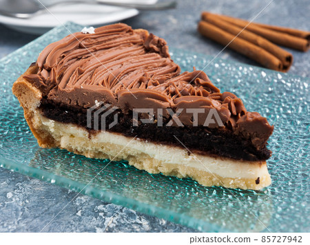 cheese and chocolate cake slice with whipped cream 85727942