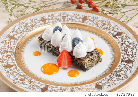 poppy seed cake with cream, strawberries and blueberries 85727988