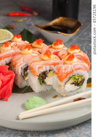 sushi rolls with salmon, cream cheese and avocado 85728196