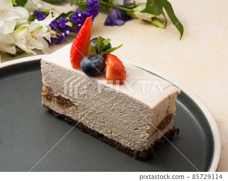 tiramisu is a classic Italian dessert on a dark plate tiramisu is a classic Italian dessert on a dark plate 85729114