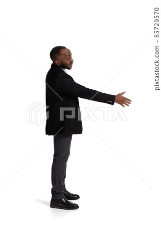 Full-length side view portait of businessman lending hand for shaking isolated over white background 85729570