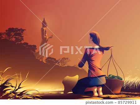 a young female farmer is kneeling on the ridge rice farm and worshiping the Buddha for his teachings and goodness. 85729911