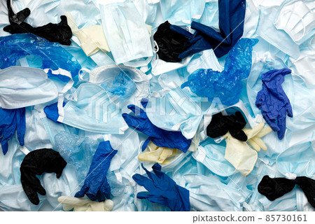 Waste of used personal protective equipment PPE gloves, disposable masks, shoe covers of medical workers in the form of a background. Garbage contamination after the COVID-19 pandemic 85730161