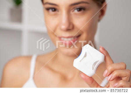 Smiling women use dental floss white healthy teeth. 85730722