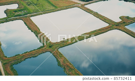 Aerial View Retention Basins, Wet Pond, Wet Detention Basin Or Stormwater Management Pond, Is An Artificial Pond With Vegetation Around The Perimeter, And Includes A Permanent Pool Of Water In Its 85732411