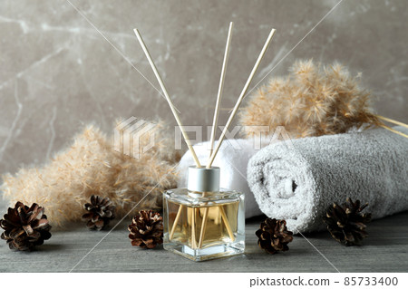 Diffuser and bath accessories on gray textured table Diffuser and bath accessories on gray textured table 85733400
