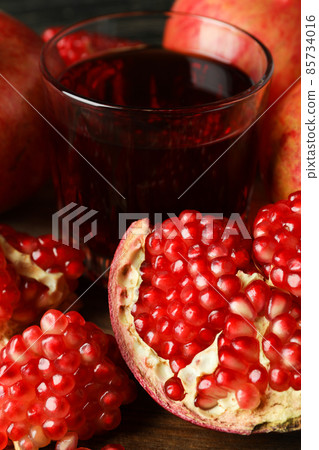 Glass of pomegranate juice and ingredients, close up Glass of pomegranate juice and ingredients, close up 85734016