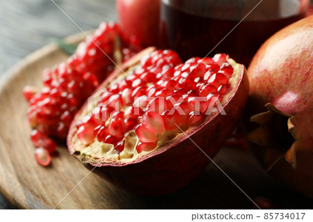 Glass of pomegranate juice and ingredients, close up Glass of pomegranate juice and ingredients, close up 85734017