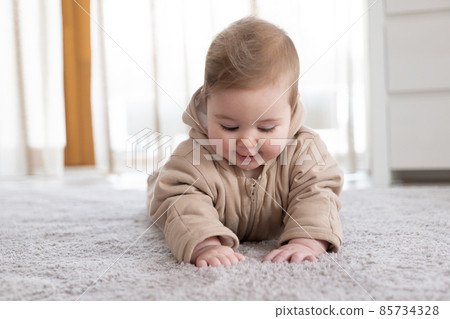 Happy baby crawling on floor or carpet Happy baby crawling on floor or carpet 85734328