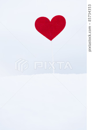 Red heart on stick in the snow outdoors 85734353