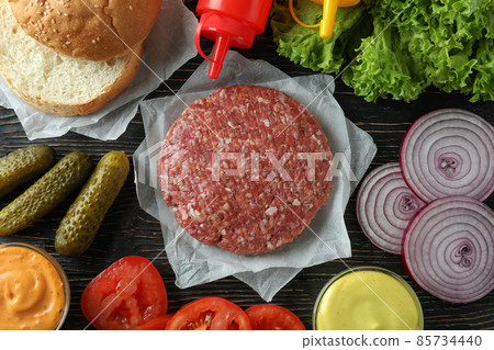 Concept of cooking burger on wooden table Concept of cooking burger on wooden table 85734440