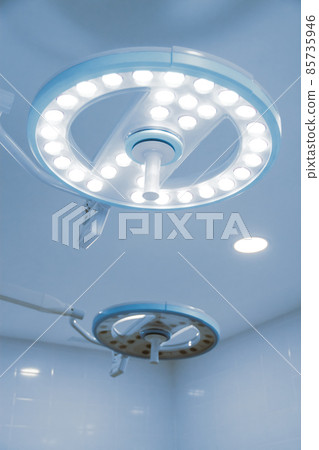 Empty interior operating room and modern equipment in hospital. Medical device for surgeon surgical emergency patient in blue tone style. Save life medical treatment concept. Empty interior operating room and modern equipment in hospital. Medical device for surgeon surgical emergency patient in blue tone style. Save life medical treatment concept. 85735946