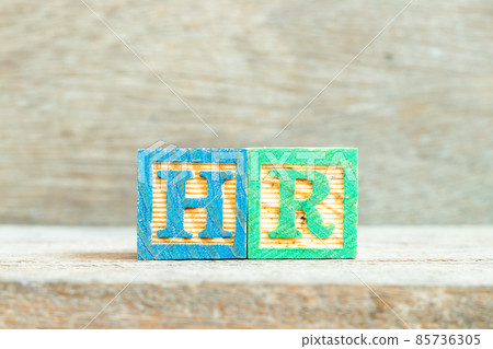 Color alphabet letter block in word HR (Abbreviation of human resource) on wood background Color alphabet letter block in word HR (Abbreviation of human resource) on wood background 85736305