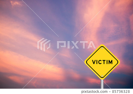 Yellow transportation sign with word victim on blue sky background 85736328