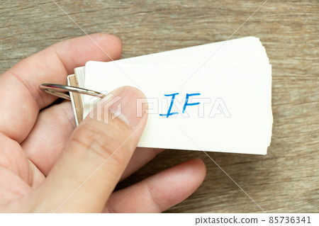 Man hold the flash card with handwriting word if on wood background 85736341