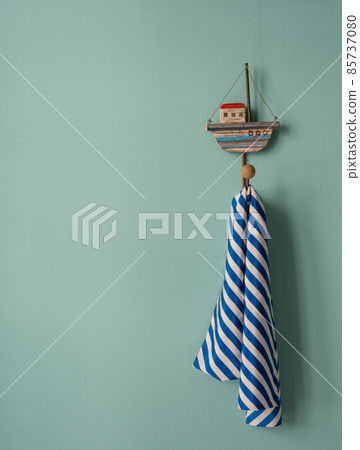 Annual vacation and travel vacation planning. A blue-striped neckerchief hangs from a hook in the shape of a ship 85737080