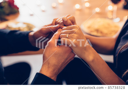 Couple having dinner, focus on hands and ring 85738328