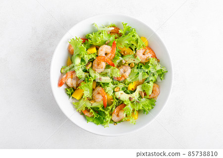 Grilled shrimp salad with avocado, mango, lettuce and pistachios, dressed with lime. Healthy food. Ketogenic diet. Top view. Grilled shrimp salad with avocado, mango, lettuce and pistachios, dressed with lime. Healthy food. Ketogenic diet. Top view. 85738810
