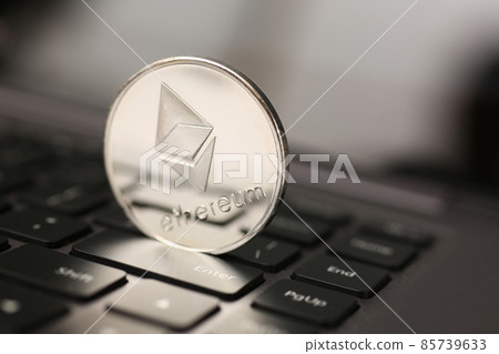 Ethereum silver coin on laptop pc keyboard Ethereum silver coin on laptop pc keyboard 85739633