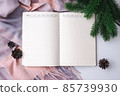 Notebook for goals and plans. Flat lay composition with Cashmere scarf, fir branches and cones. 85739930