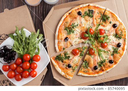 Sliced thin crust pizza with salmon in cardboard box 85740095