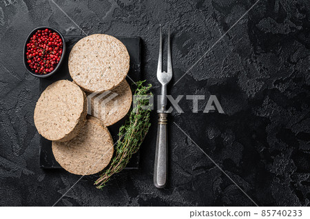 Uncooked Burgers cutlets made from plant based meat, raw vegan patties. Black background. Top view. Copy space Uncooked Burgers cutlets made from plant based meat, raw vegan patties. Black background. Top view. Copy space 85740233