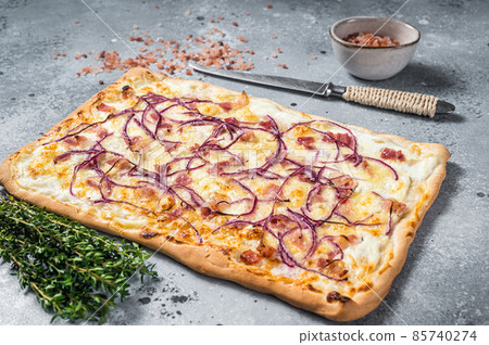 Traditional German Flammkuchen pie with ham and onion. Gray background. Top view Traditional German Flammkuchen pie with ham and onion. Gray background. Top view 85740274