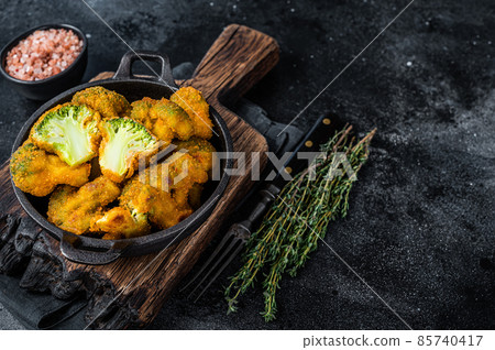 Roasted Crumbed broccoli in a pan. Black background. Top view. Copy space Roasted Crumbed broccoli in a pan. Black background. Top view. Copy space 85740417