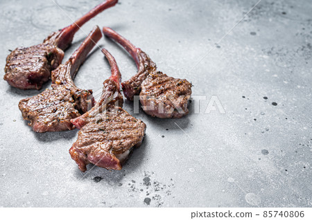 Grilled lamb mutton meat chops steaks. Gray background. Top view. Copy space 85740806