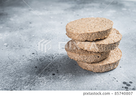 Raw Meat Free Plant Based Burger patties, vegetarian cutlets. Gray background. Top view. Copy space Raw Meat Free Plant Based Burger patties, vegetarian cutlets. Gray background. Top view. Copy space 85740807