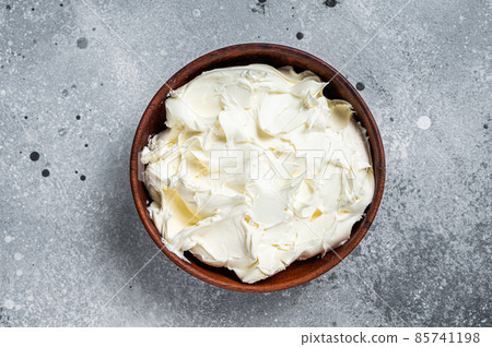 Traditional Mascarpone cheese in wooden bowl. Gray background. Top view 85741198