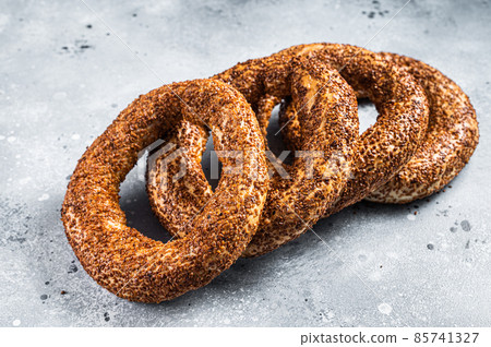 Turkish Bagel Simit with sesame traditional pastry. Gray background. Top view Turkish Bagel Simit with sesame traditional pastry. Gray background. Top view 85741327