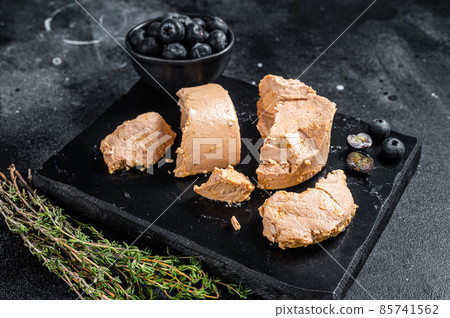 Foie gras duck liver pate and fresh blueberry. Black background. Top view 85741562