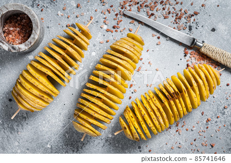 Cooking Tornado or Twist potato fries. Gray background. Top view 85741646