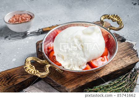 Burrata Italian cheese made from cream and milk of buffalo or cow. Gray background. Top view Burrata Italian cheese made from cream and milk of buffalo or cow. Gray background. Top view 85741662