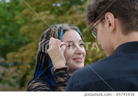 Young family. A cheerful woman pinches her eyebrow. Young family. A cheerful woman pinches her eyebrow. 85741916