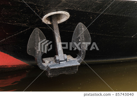 A metal anchor on the blackboard the ship.  85743040
