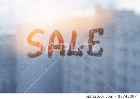 Foggy glass on window with written finger red word Sale on muddy sunset glass wet window 85743097