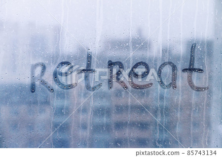 Lettering handwritten word Retreat on foggy blue window concept of reboot, goal setting, copy space Lettering handwritten word Retreat on foggy blue window concept of reboot, goal setting, copy space 85743134