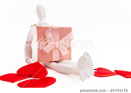 Wooden man figure with Valentines Day gift box, white background. Copy space Wooden man figure with Valentines Day gift box, white background. Copy space 85743176