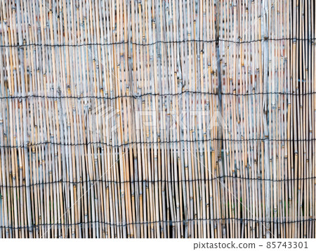 Bamboo trunks tied like a garden fence. Traditional Asian material Bamboo trunks tied like a garden fence. Traditional Asian material 85743301