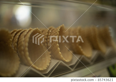 Waffle cones for ice cream. Sweets on the shop window. Waffle cones for ice cream. Sweets on the shop window. 85743621