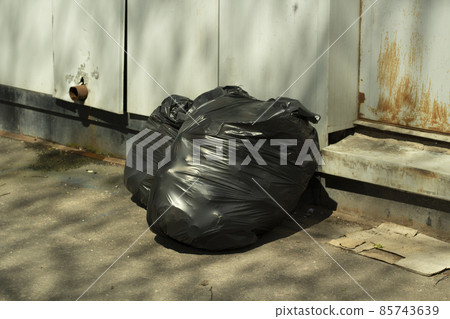 Garbage in bags. Black bags of waste. Plastic bags. 85743639